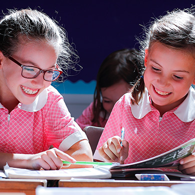 2 students looking through a book