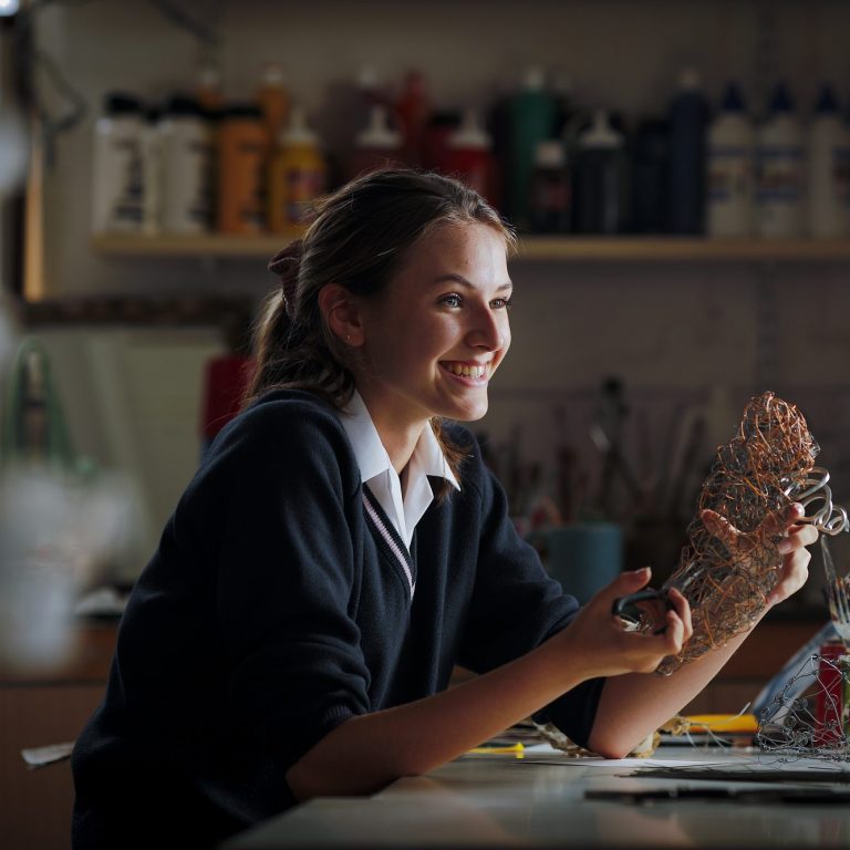 girl holding her art work