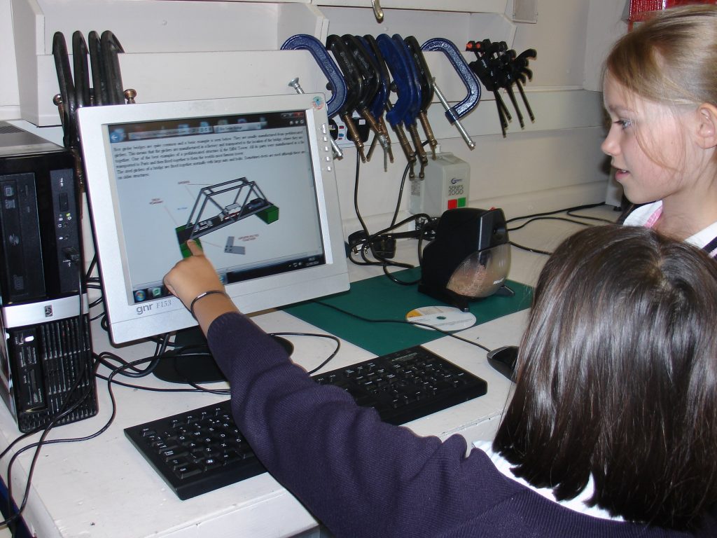 student looking at device on PC screen