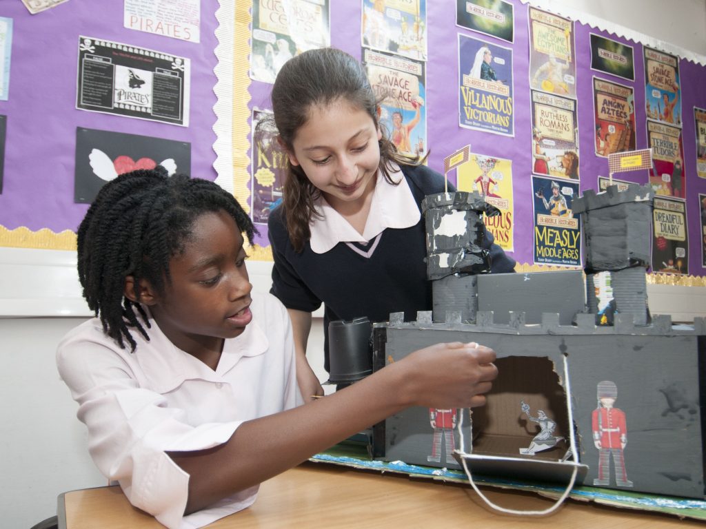 students looking at a cardboard construction of the Tower of London