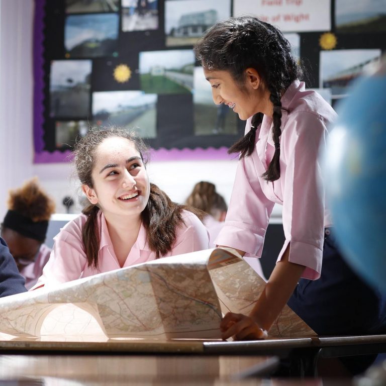 girls reading a map