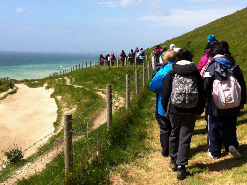 students walking along the coast