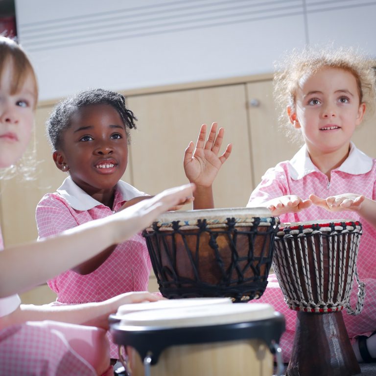 girls banging drums