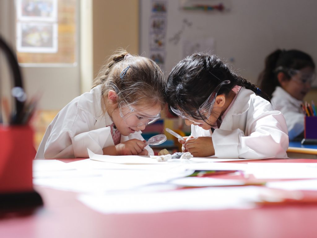 Little girls wearing science gear