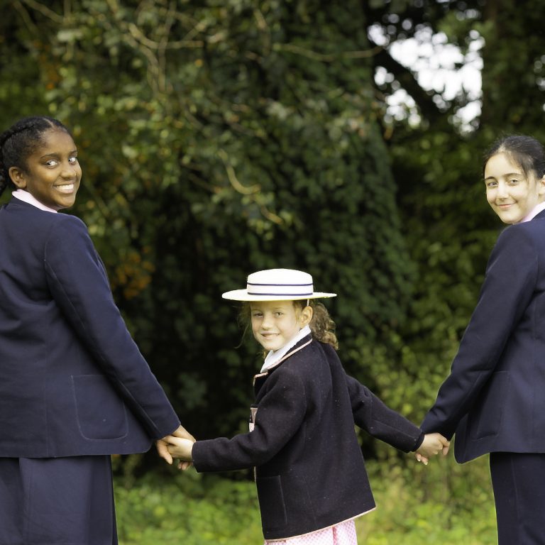 girls of different ages holding hands