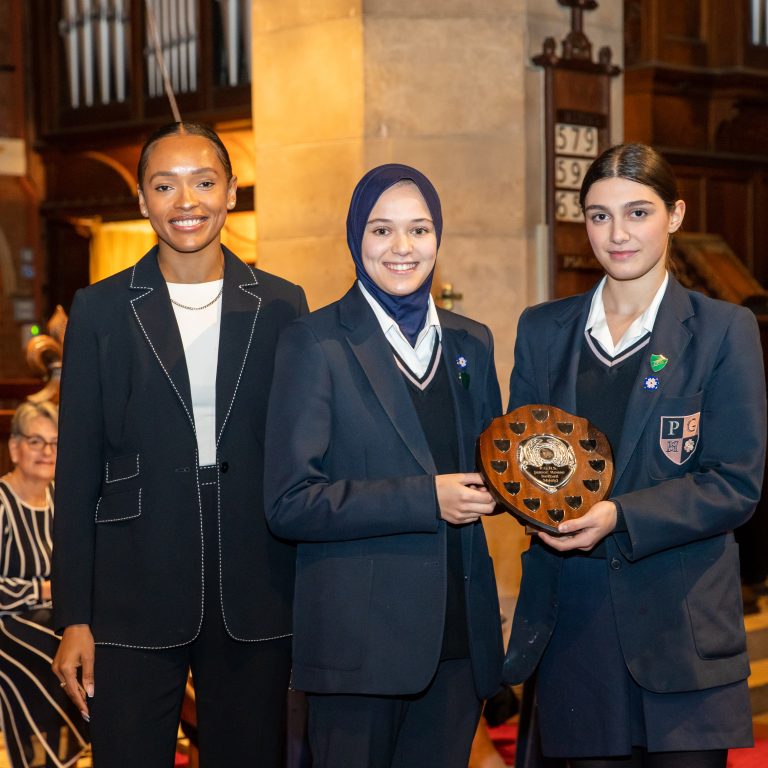 girls holding an award
