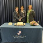 Student and teacher cutting a cake