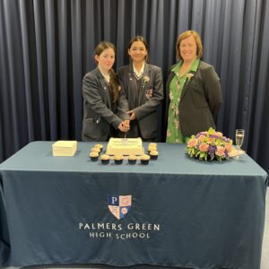 Student and teacher cutting a cake