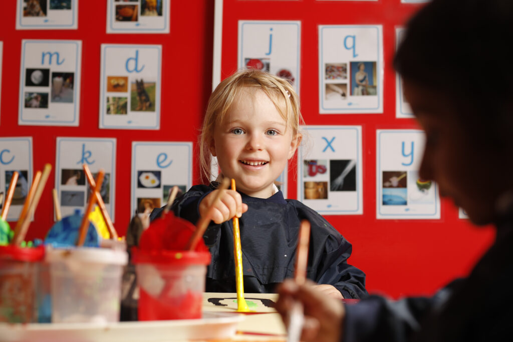 student with paintbrush in her hand