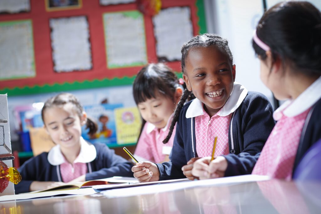 students sat at a table doing work