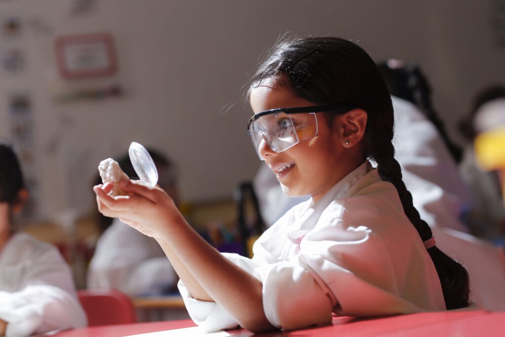 student holding up a crystal