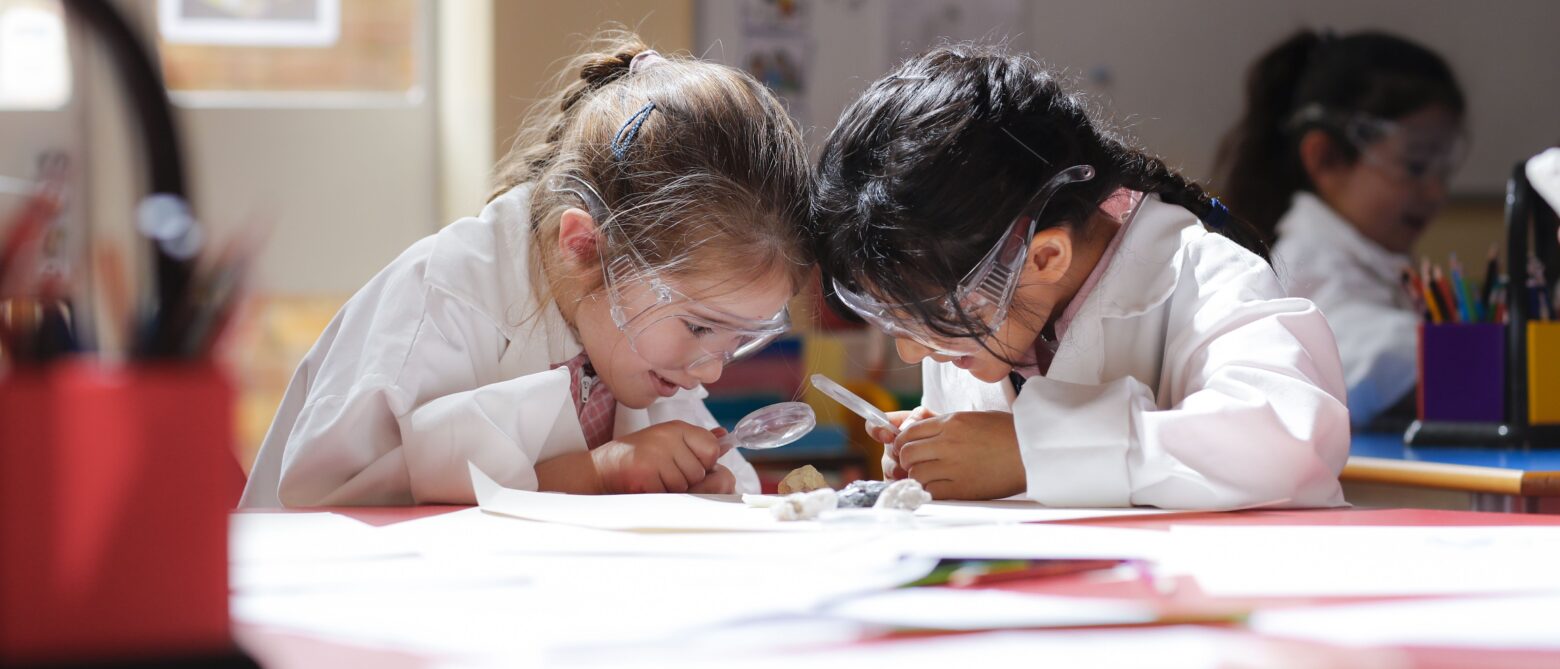 students using magnifying glasses