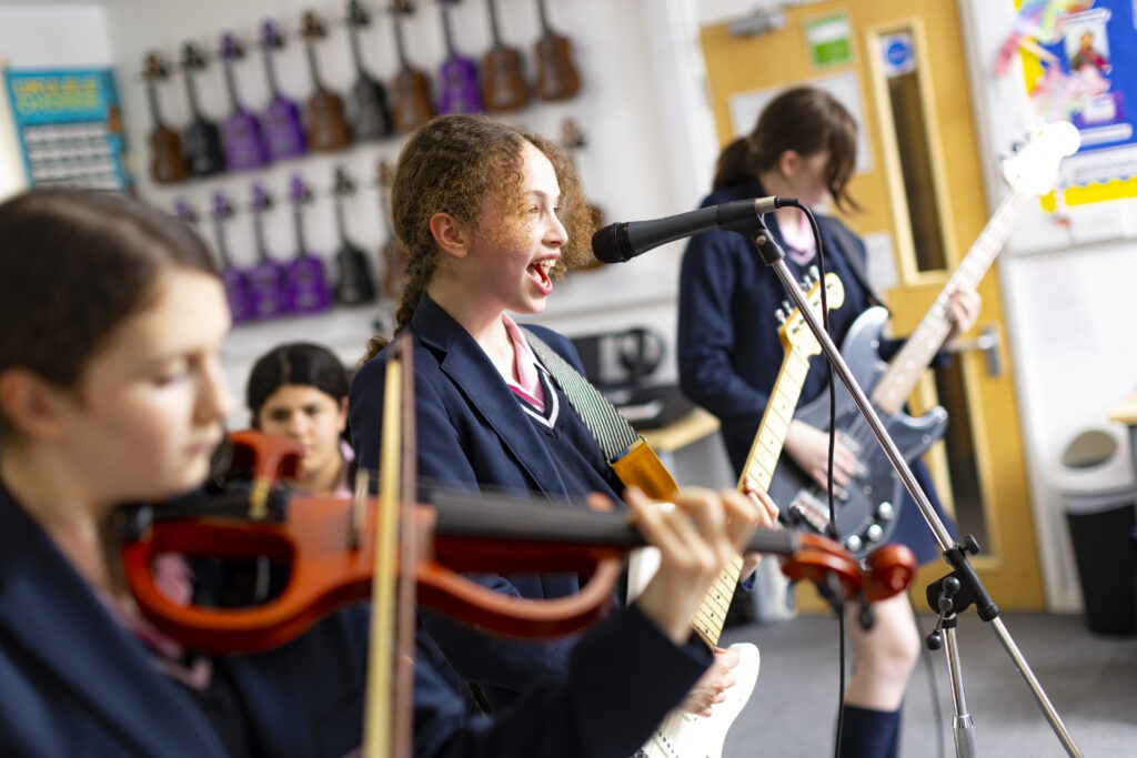 girls playing music in a band together